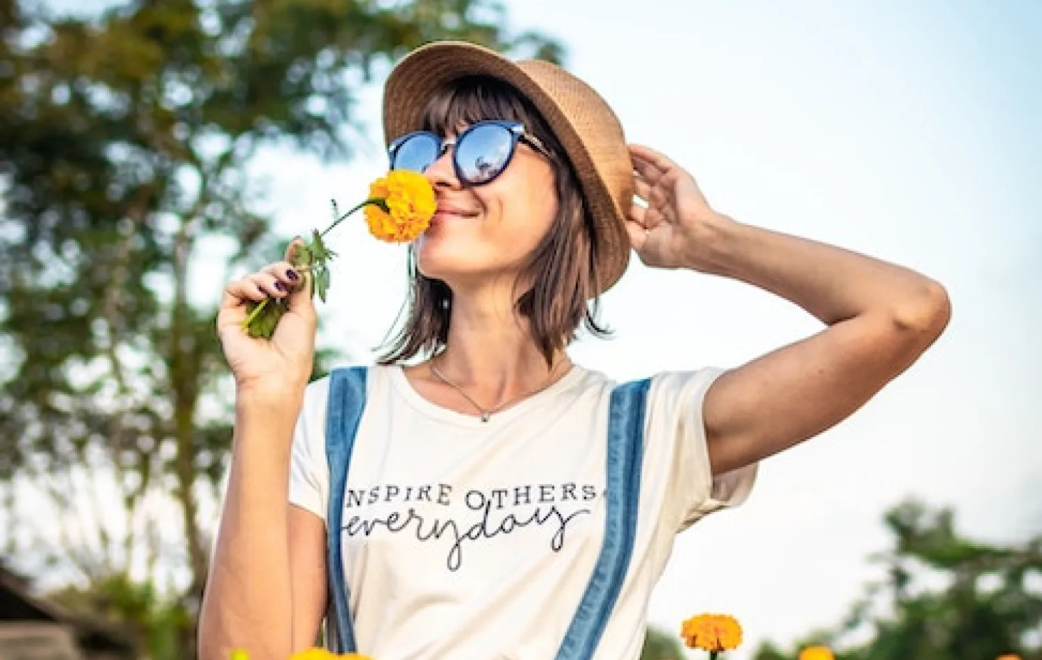 woman smelling flowers as she takes time for herself and embraces personal growth