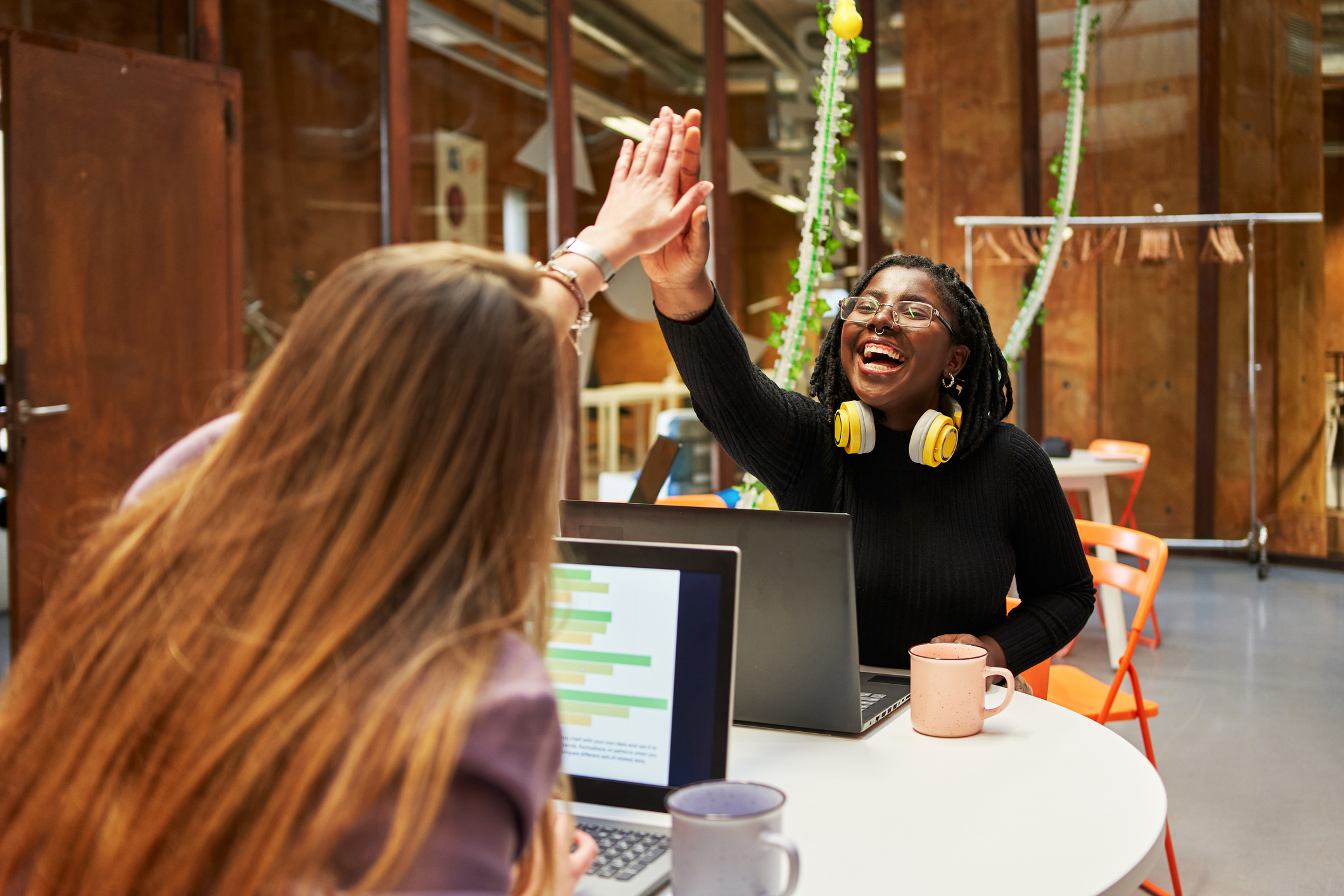 employee empowerment with two happy colleagues giving high-fives
