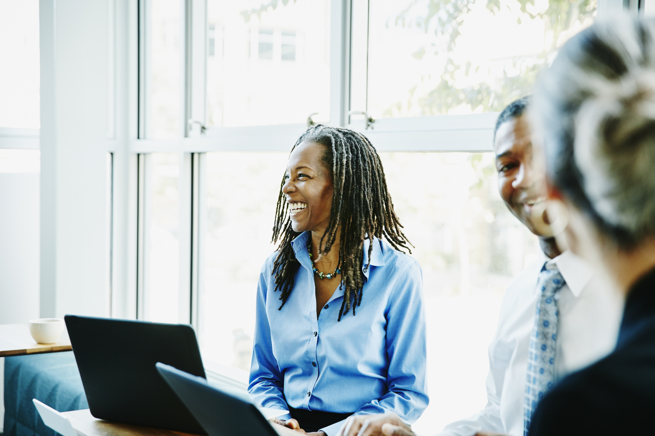 laughing businesswoman shows value of belonging in workplace