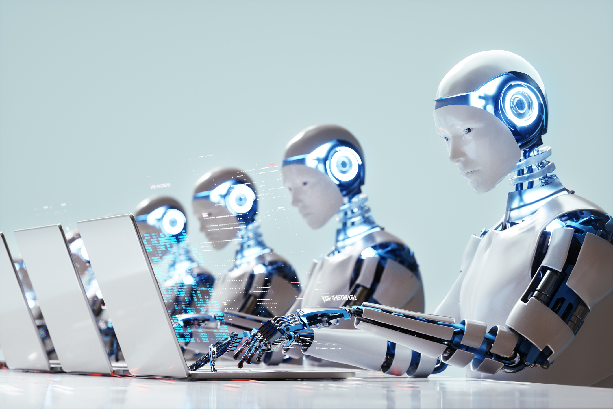 Impact of AI on workforce illustrated by robots working on computers