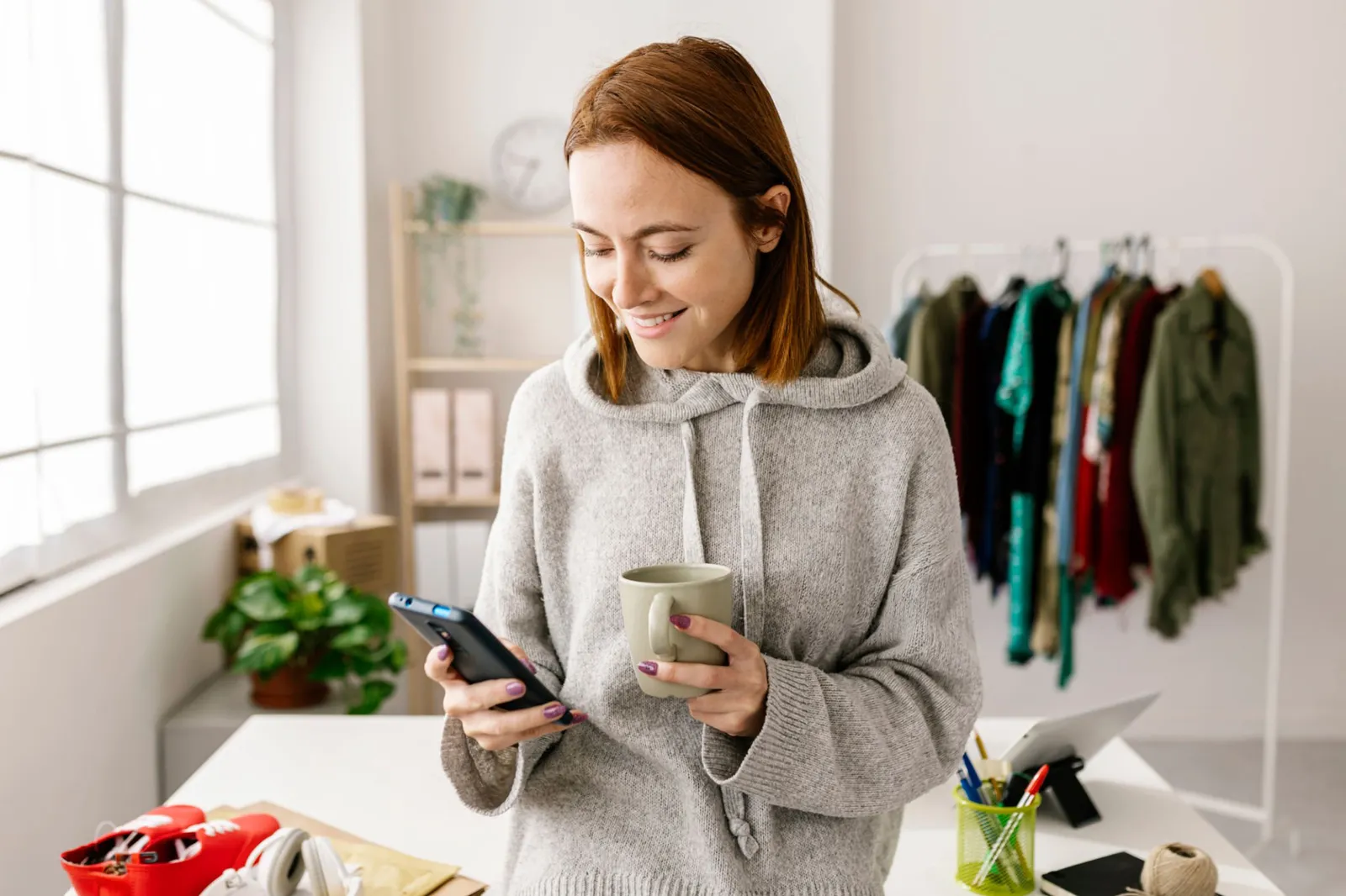 A retail associate reviewing customer feedback on a mobile device